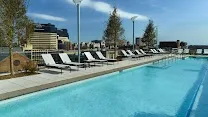 Rooftop pool with sunny lounging area
