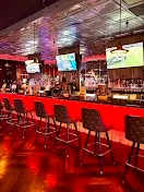 Full bar with TVs and custom cocktails