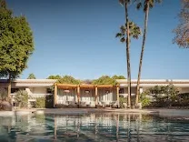 Two pools and a sandy beach area