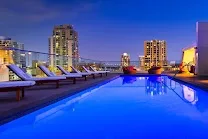 Trendy rooftop bar and pool with downtown skyline views
