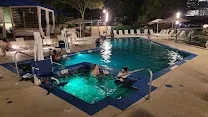 Outdoor pool and hot tub by the water