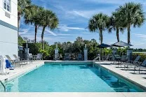 Outdoor pool and hot tub with firepit seating