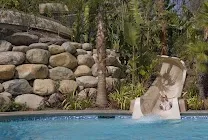 Multiple lagoon pools with water slides and hot tub